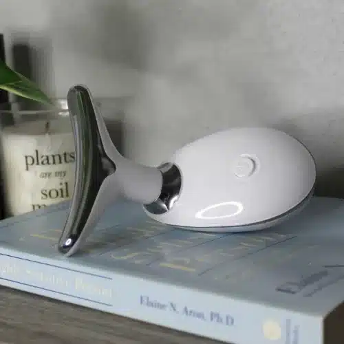 EMS face lifting and tightening device placed on a book