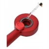 Close-up of oil container and dropper for scalp massage comb