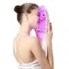 Woman comfortably using LED light therapy facial mask at home